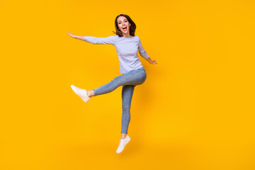 Fototapeta na wymiar Full length body size view of her she attractive pretty lovely funky cheerful cheery girl jumping having fun fooling dancing isolated bright vivid shine vibrant yellow color background
