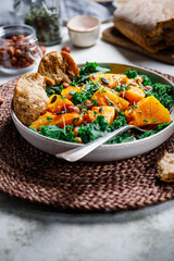 Season salad with grilled pumpkin, kale, chickpea, pepitas and nuts. Autumn vegetarian healthy recipe.