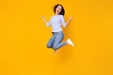 Fototapeta na wymiar Full length body size view of her she attractive pretty lucky cheerful cheery girl jumping rejoicing having fun good mood attainment isolated bright vivid shine vibrant yellow color background
