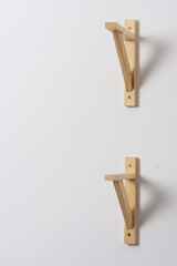The process of attaching a wooden shelf to the wall, shelf corners