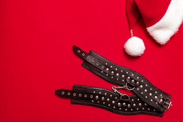 Red color banner with black leather bracers and metal rivets for shackling hands or legs and...