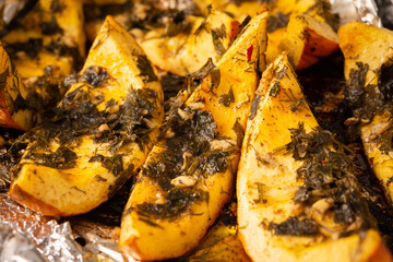 Baked pumpkin, pieces of pumpkin with dill and parsley, spices and lemon juice baked in foil in the oven