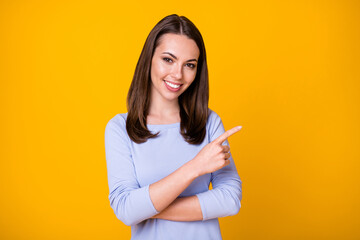 Photo of positive cheerful girl point index finger copyspace demonstrate adverts promo recommend...