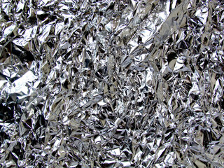 Сrumpled, shiny, silver, aluminum foil. Texture, background