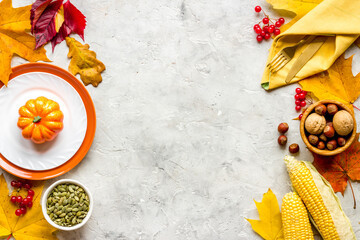 Thanksgiving holidays concept with dishes and pumpkins, top view