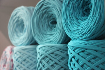 t-shirt yarn balls light blue color on shop shielf. Handmade craft recycle eco concept