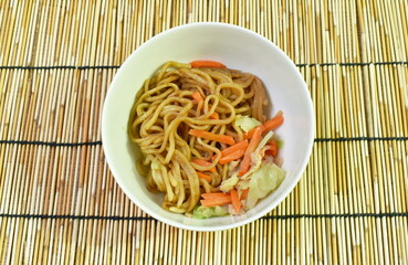 fried yakisoba Japanese noodles slice pork and cabbage with carrot on bowl