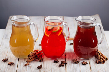 Different fruit lemonades in glass jugs