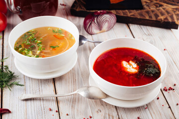 Side view on two soups borsch and vegetable