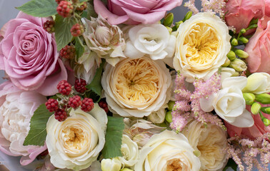 Colorful flowers assorted bouquet in paper. Holiday celebration concept. Bouquet of beautiful flowers in hands. Work of florist.