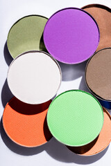 close up view of multicolored eyeshadow on white background