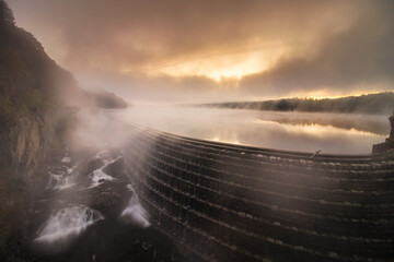 Ethereal moody sunrise with low fog and steam being illuminated over a lake and waterfall. Croton Gorge, New York © Scott Heaney