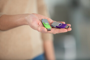 hands holds usb flash drives