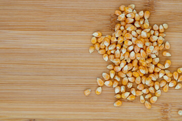 corn kernels for popcorn on a wooden board