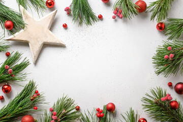 Fototapeta na wymiar Christmas frame with red decor, white DIY star on white background. Xmas greeting card with copy space.