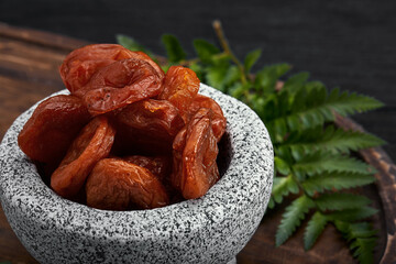dried apricots on a dark wood background. tinting. selective focus