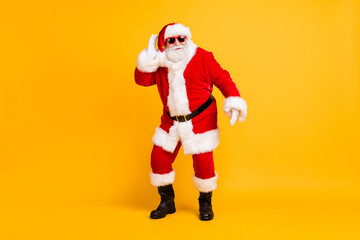 Full length body size view of his he nice funny cheery positive white-haired Santa St Nicholas dancing having fun rest chill isolated bright vivid shine vibrant yellow color background