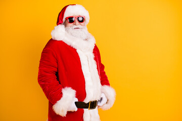 Fototapeta na wymiar Portrait of his he nice funny confident serious white-haired Santa holding belt wearing winter warm fluffy look outfit garment isolated bright vivid shine vibrant yellow color background