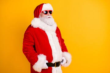 Fototapeta na wymiar Profile side view portrait of his he nice funny white-haired Santa holding belt wearing winter season fluffy look outfit clothes copy space isolated bright vivid shine vibrant yellow color background