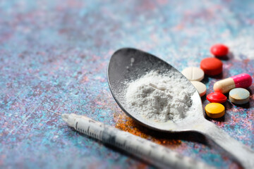 drug addiction concept with heroine packet and syringe on black backgrund 