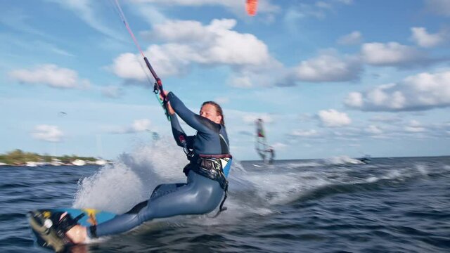 Professional kiter catching wind with his kite. Windy day on a coast