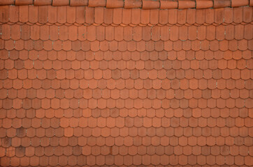 view of the roof made of red brick burnt tiles of the beaver type used in Central Europe on all historical roofs, especially in Austria. the bags overlap several times, they look like beaver teeth © Michal