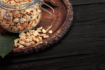 Deep fried peanuts on dark table background