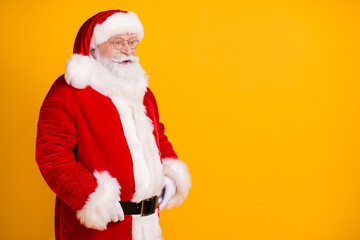 Fototapeta na wymiar Profile side view portrait of his he nice cheerful cheery confident white-haired Santa copy empty blank place space ad advert isolated over bright vivid shine vibrant yellow color background