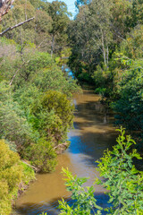 A calm tranquil scene of Merri Creek flowing through the suburbs of Melbourne Australia