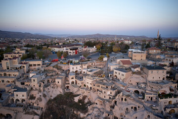 The city of Ortahisar with old houses, top view. Sunset sky in the background. Cappadocia, Turkey.