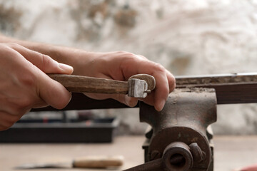 Male carpenter working on old wood in a retro vintage style.
