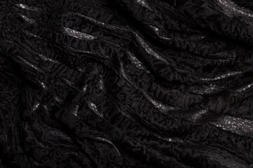 Texture black astrakhan fur skin. Background.