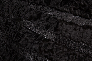 Texture black astrakhan fur skin. Background.