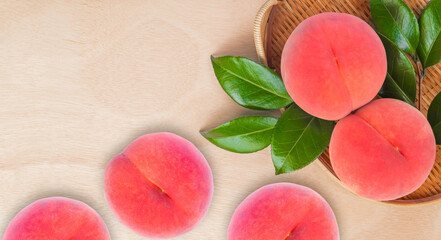 Obraz na płótnie Canvas Fresh Japan Pink Peach with leaves on wooden background, Delicious organic healthy fruit in autumn.