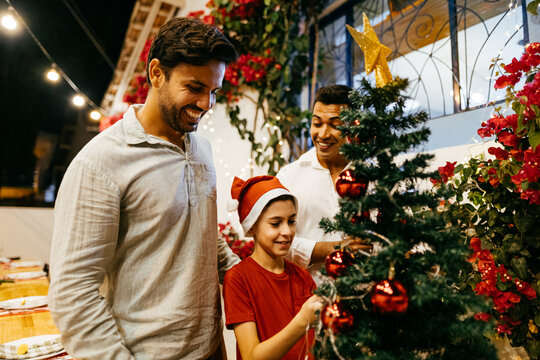 Christmas in Brazil. Family decorating Christmas tree