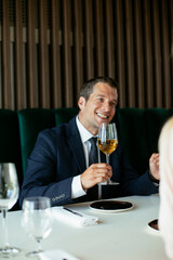 Handsome businessman drinking wine. Businessman enjoying in the restaurant