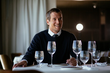 Handsome businessman drinking wine. Businessman enjoying in the restaurant