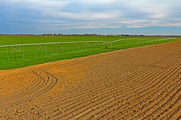 Green farmland with large boom irrigation