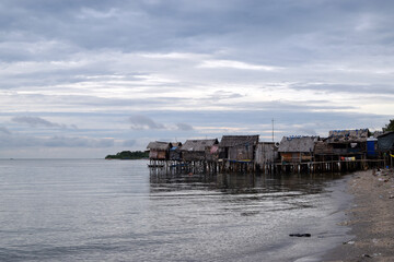 Over water stilt Bajau shanty houses built by indigenous people in the philippines. Long shot