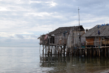 Bamboo poles support the stilt Bajau shanty houses built by indigenous people in the philippines. lmedium long shot