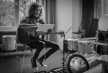 Guitarist Read Song Lyrics On Tablet .