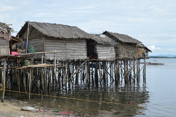 Bamboo poles support the stilt Bajau shanty houses built by indigenous people in the philippines....
