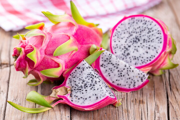 Dragon fruit isolated on wooden background, fresh pitahaya