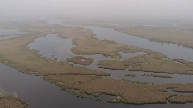 Aerial view of the Misty Autumn Floodplains of the Dnieper River with Reed islands in the river