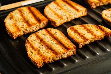 Toasting czech bread on grill