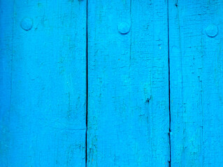 Fototapeta na wymiar texture of old painted shabby rustic wooden fence made of planks, with rusty nails, grunge background