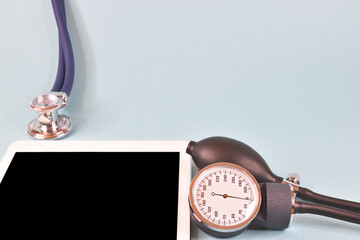 Acoustic stethoscope head descending to the tablet, blower and pressure gauge.