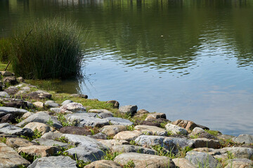 Fototapeta na wymiar Rocks by the pond
