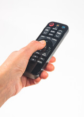 hand holding a remote control on white background, close-up