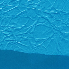 Blue torn paper collage close-up. Texture made from various paper and cardboard parts. Damaged old paper background. Vintage blank wallpaper. Material design backdrop.